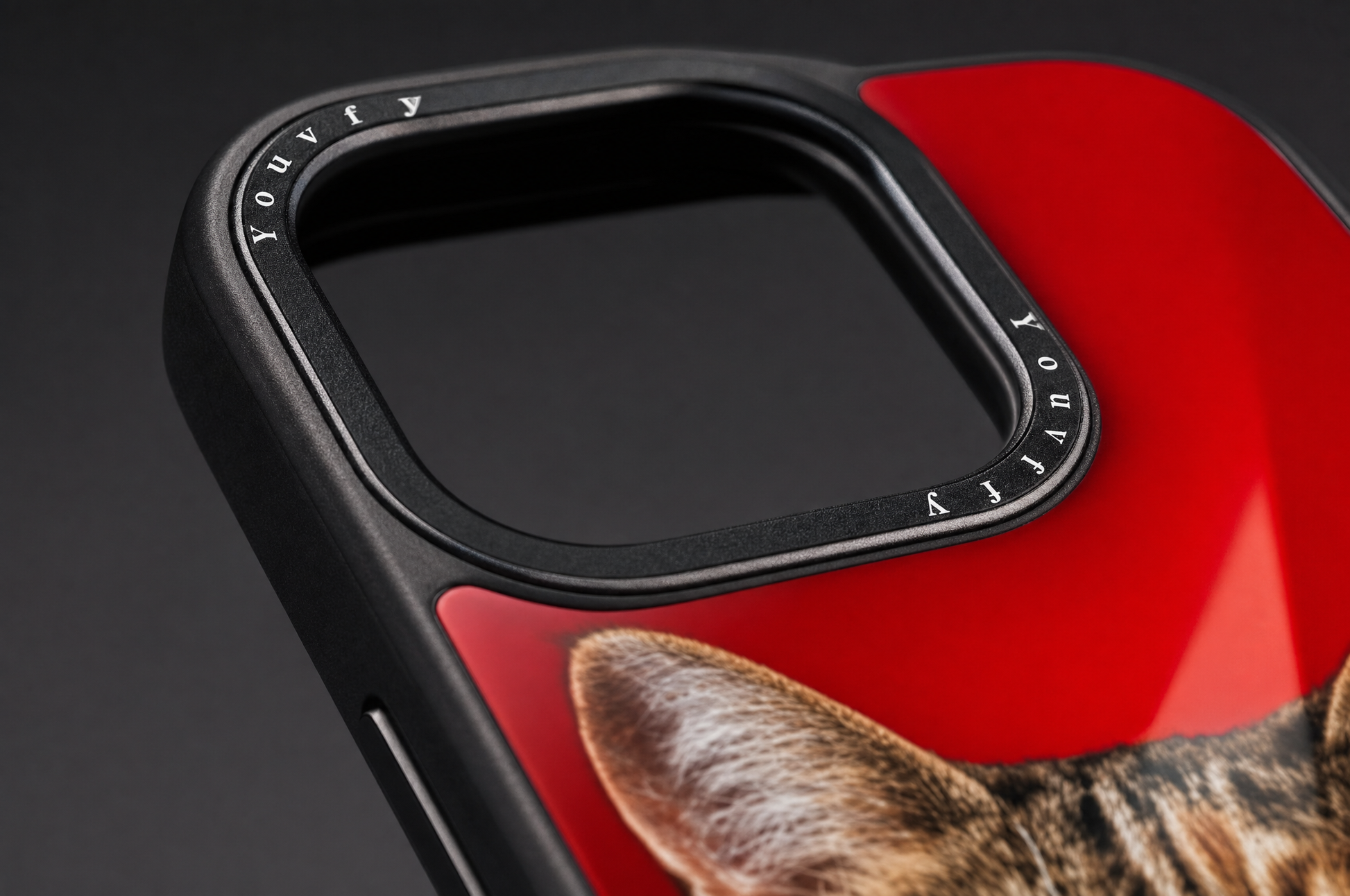 Macro detail of the Youvfy script wordmark printed around the camera ring on a flat-printed iPhone case